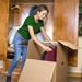 woman organizing wardrobe moving box