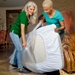 women putting mattress bag on mattress